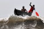 Cameroon Fishermen on the top of a wave