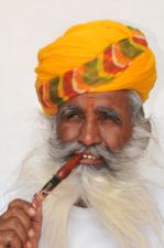 India man smoking pipe