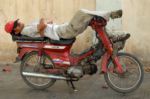 Cambodia taxidriver sleeping on his motorcycle