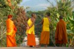 Laos four monks in a perfect setting