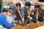 Vietnam five men are smoking pipe on local market